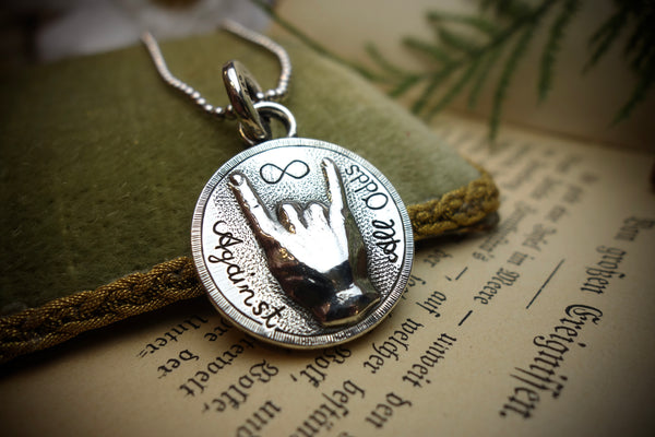 Silver Pendant „AGAINST ALL ODDS“