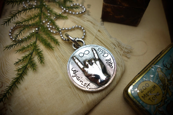 Silver Pendant „AGAINST ALL ODDS“